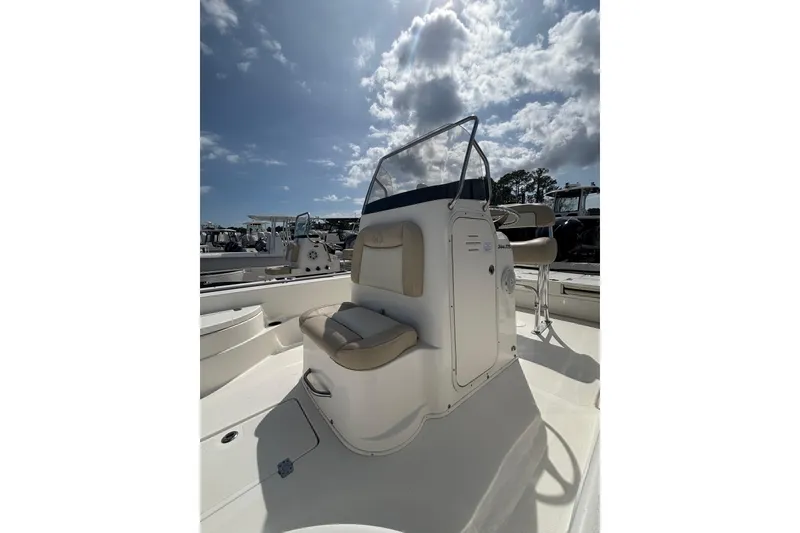 Slide: The Image of 2018 NauticStar 244 XTS boat interior under a partly cloudy sky. - 5