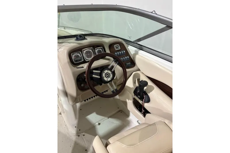 Slide: The Image of 2008 Chaparral 246 SSi boat cockpit with steering wheel and control panel. - 10