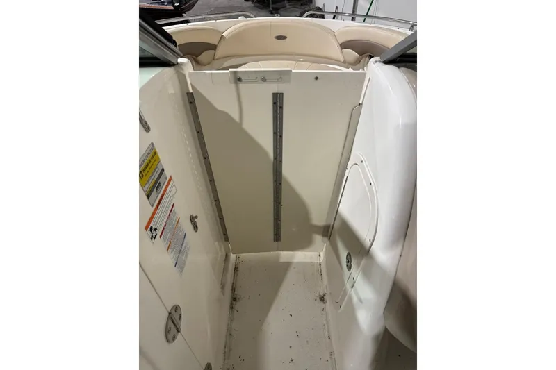 Slide: The Image of 2008 Chaparral 246 SSi boat interior with seating and storage area. - 12