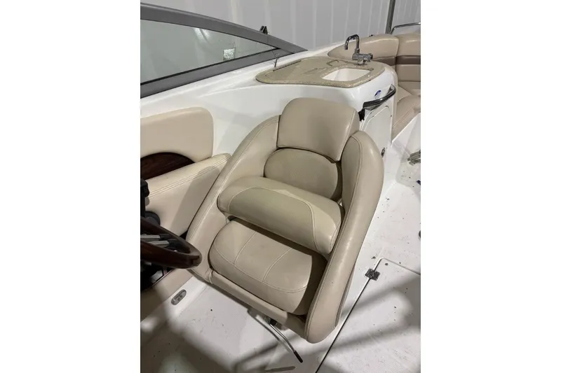 Slide: The Image of 2008 Chaparral 246 SSi boat interior with beige seating and sink area. - 13