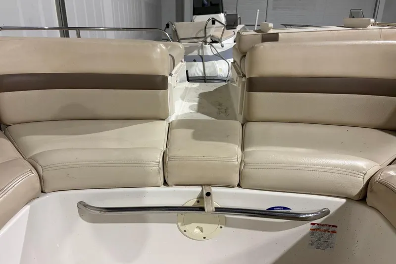 Slide: The Image of 2008 Chaparral 246 SSi boat interior with beige seating and stainless steel railing. - 15