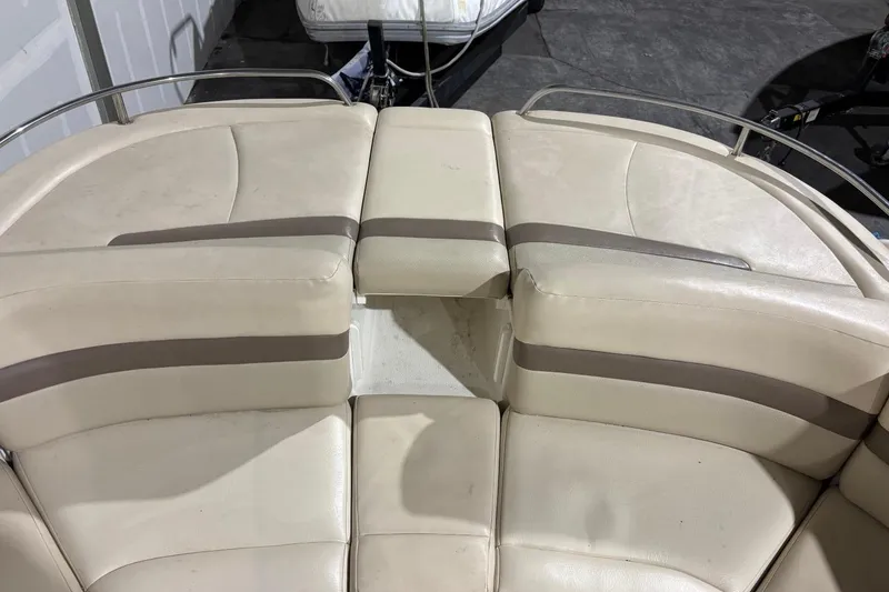 Slide: The Image of 2008 Chaparral 246 SSi boat interior with beige seating and metal railings. - 16