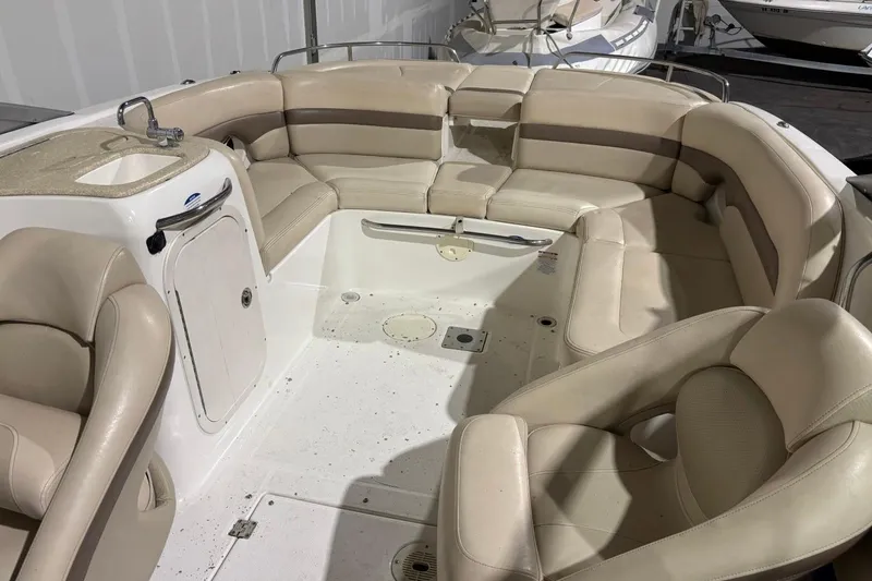 Slide: The Image of 2008 Chaparral 246 SSi boat interior with beige seating and compact sink area. - 18