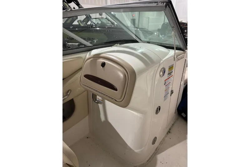 Slide: The Image of 2008 Chaparral 246 SSi boat interior with beige dashboard and windshield. - 19