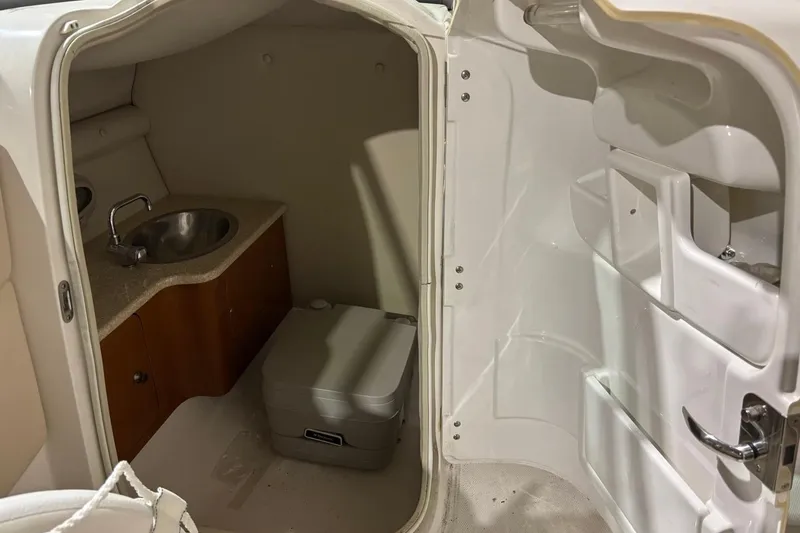 Slide: The Image of Interior of 2008 Chaparral 246 SSi boat bathroom with sink and portable toilet. - 22