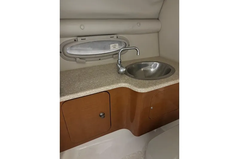 Slide: The Image of 2008 Chaparral 246 SSi boat interior with sink and storage cabinet. - 24