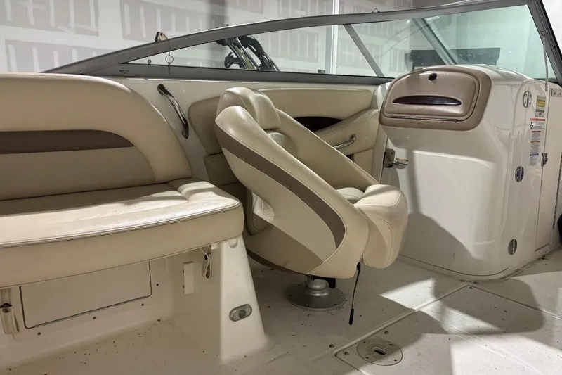 Slide: The Image of 2008 Chaparral 246 SSi boat interior with beige seating and dashboard. - 28