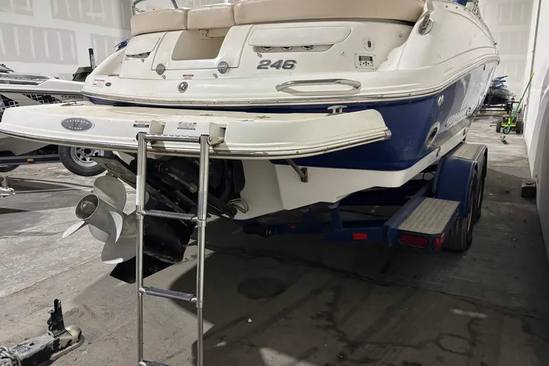Slide: The Image of 2008 Chaparral 246 SSi boat on trailer, rear view with propeller and ladder visible. - 32