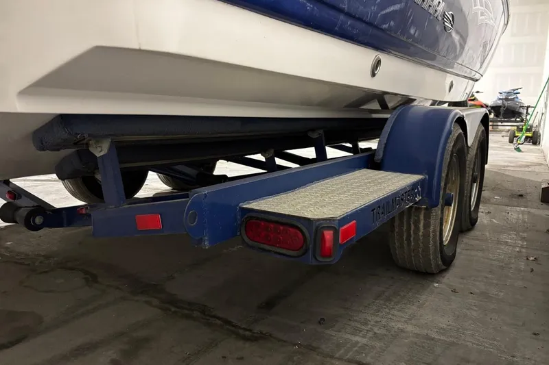 Slide: The Image of 2008 Chaparral 246 SSi boat on a blue trailer in a garage setting. - 33
