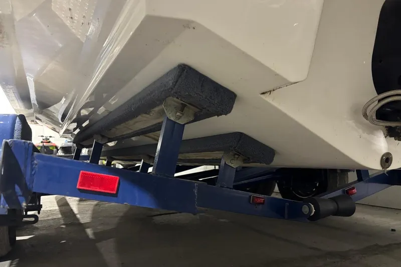 Slide: The Image of 2008 Chaparral 246 SSi boat on blue trailer, underside view with red reflector. - 35