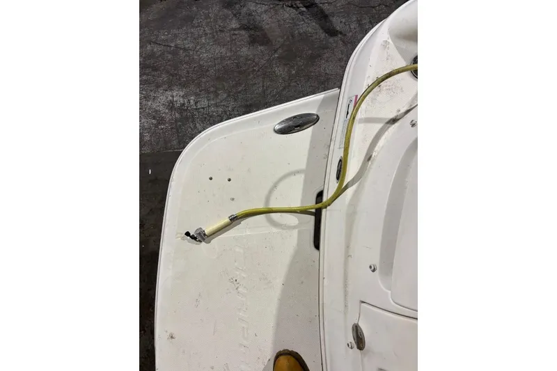 Slide: The Image of 2008 Chaparral 246 SSi boat deck with attached yellow hose. - 42