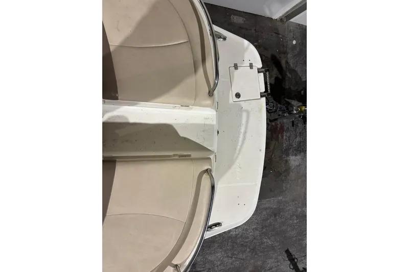 Slide: The Image of 2008 Chaparral 246 SSi boat interior with beige seating and white deck. - 8
