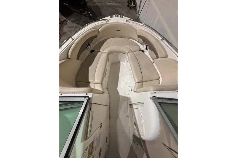 Slide: The Image of 2008 Chaparral 246 SSi boat interior with beige seating and spacious layout. - 9