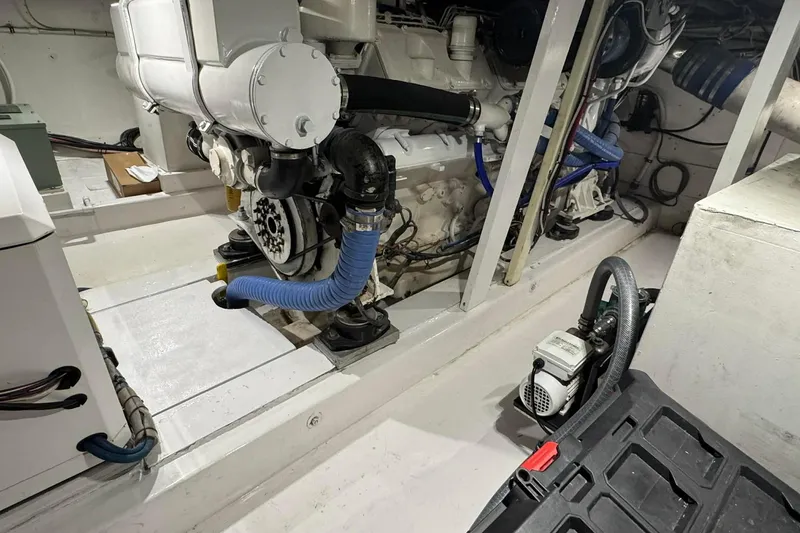 Slide: The Image of Engine room of a 1992 Blackwell Custom Carolina boat, showcasing mechanical components and piping. - 12