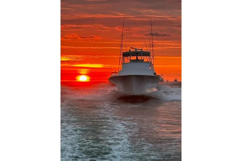 Slide: The Image of Boat cruising at sunset, Blackwell Custom Carolina 1992, vibrant orange sky. - 2