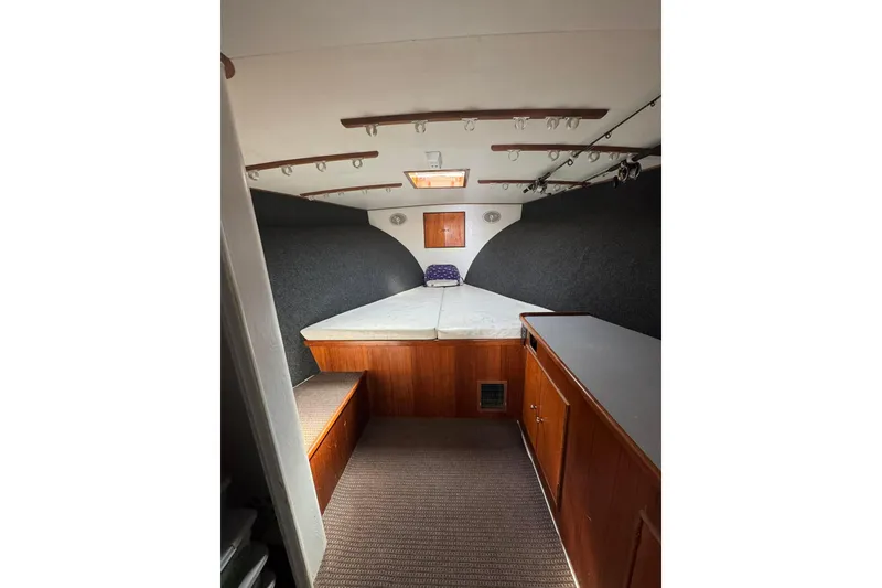 Slide: The Image of Interior cabin of 1992 Blackwell Custom Carolina boat with bed and wooden cabinetry. - 5