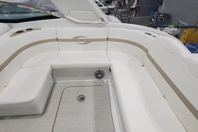 Slide: The Image of 2012 Formula 310 Sun Sport boat interior with white seating and beige accents. - 13