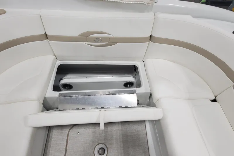 Slide: The Image of 2012 Formula 310 Sun Sport boat interior with open storage compartment and cushioned seating. - 15