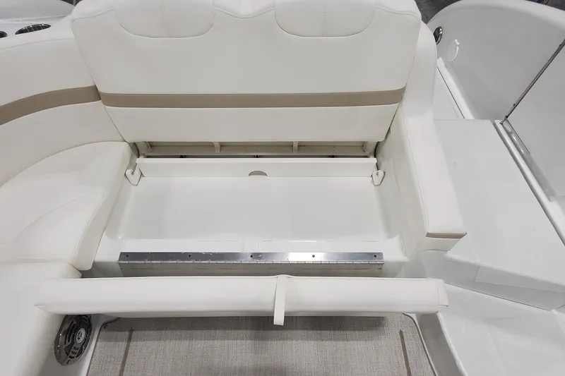 Slide: The Image of 2012 Formula 310 Sun Sport boat interior with white seating and storage compartment. - 16
