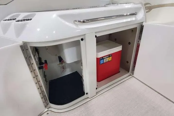Slide: The Image of Storage compartment on a 2012 Formula 310 Sun Sport boat with a red cooler. - 20