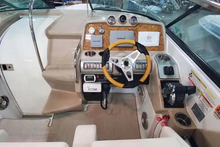 Slide: The Image of 2012 Formula 310 Sun Sport boat dashboard with steering wheel and navigation controls. - 21