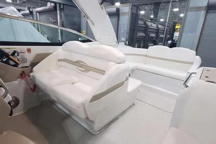 Slide: The Image of 2012 Formula 310 Sun Sport boat interior with white seating in a showroom. - 25