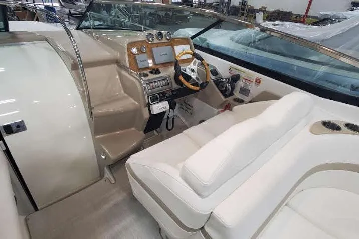 Slide: The Image of 2012 Formula 310 Sun Sport boat interior with beige seating and modern dashboard. - 26