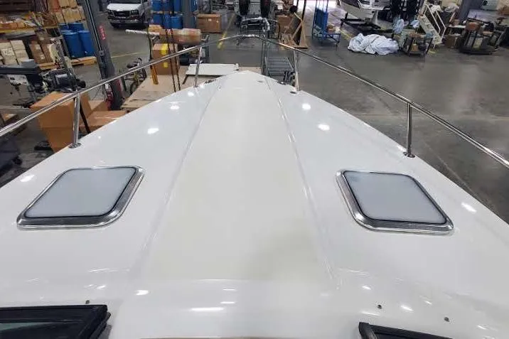 Slide: The Image of 2012 Formula 310 Sun Sport boat deck in a warehouse setting. - 28