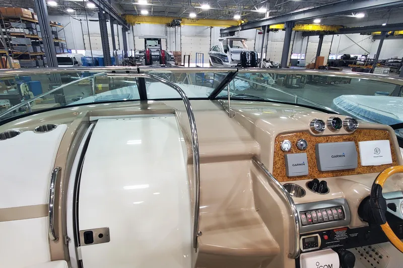 Slide: The Image of 2012 Formula 310 Sun Sport boat dashboard with Garmin navigation in a warehouse setting. - 29