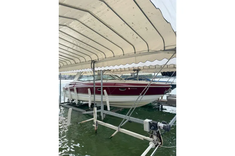 Slide: The Image of 2012 Formula 310 Sun Sport boat docked under canopy on water. - 3