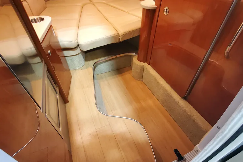 Slide: The Image of Interior of 2012 Formula 310 Sun Sport boat with beige seating and wooden flooring. - 32