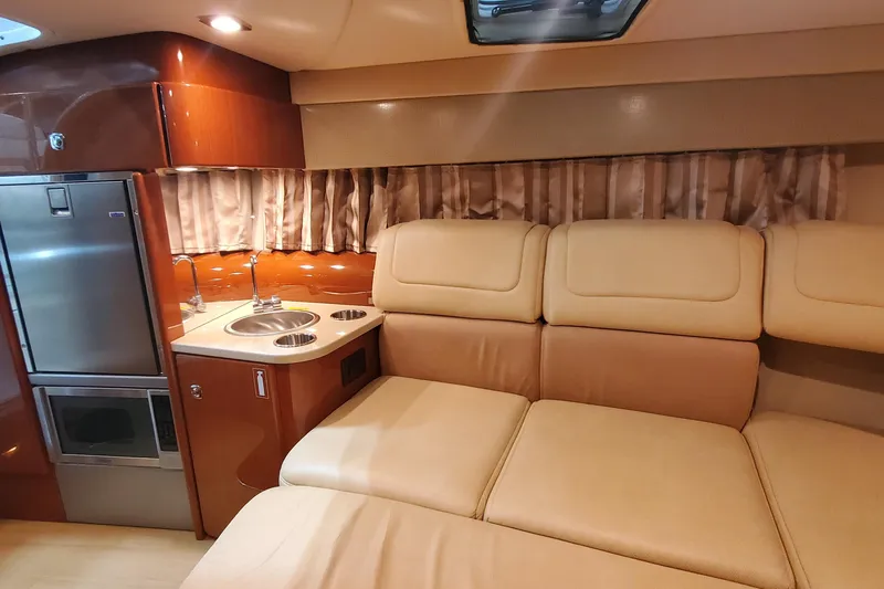 Slide: The Image of Luxurious interior of 2012 Formula 310 Sun Sport with kitchenette and beige seating. - 34