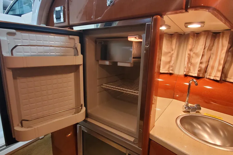 Slide: The Image of 2012 Formula 310 Sun Sport interior with open fridge and sink. - 35