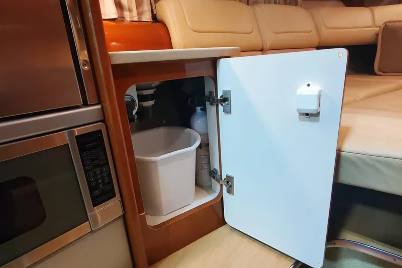 Slide: The Image of 2012 Formula 310 Sun Sport interior with open cabinet, microwave, and seating area. - 37