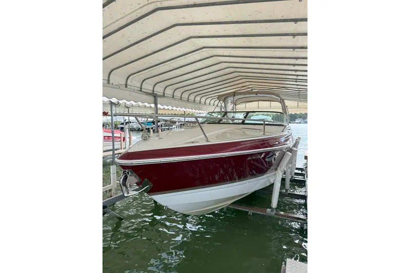 Slide: The Image of 2012 Formula 310 Sun Sport boat docked under a canopy. - 4