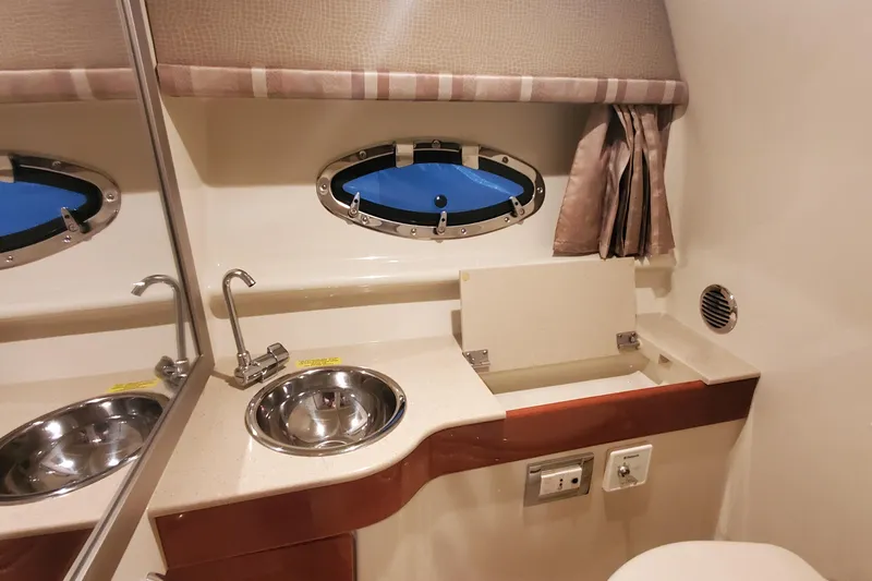 Slide: The Image of 2012 Formula 310 Sun Sport bathroom interior with sink and porthole window. - 44