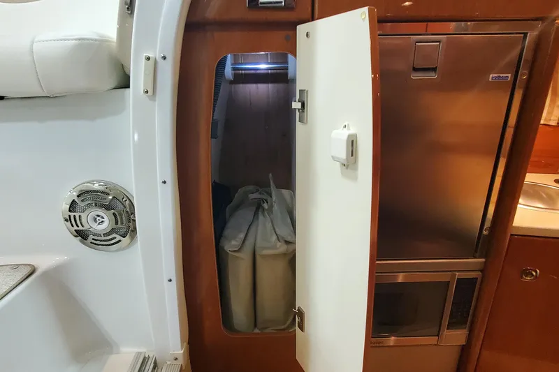 Slide: The Image of Interior of 2012 Formula 310 Sun Sport boat with open storage compartment and appliances. - 45