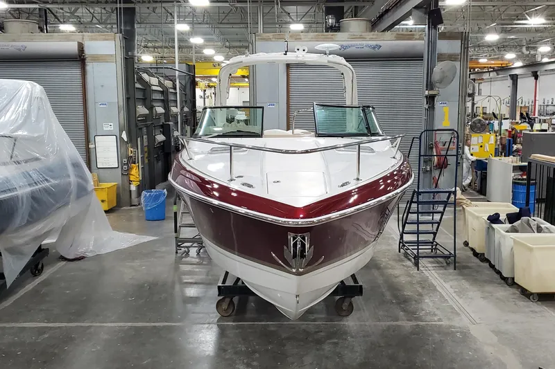 Slide: The Image of 2012 Formula 310 Sun Sport boat in a workshop setting. - 5