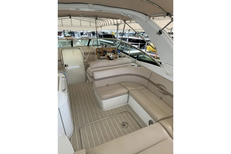 Slide: The Image of 2012 Formula 310 Sun Sport boat interior with beige seating and helm. - 50