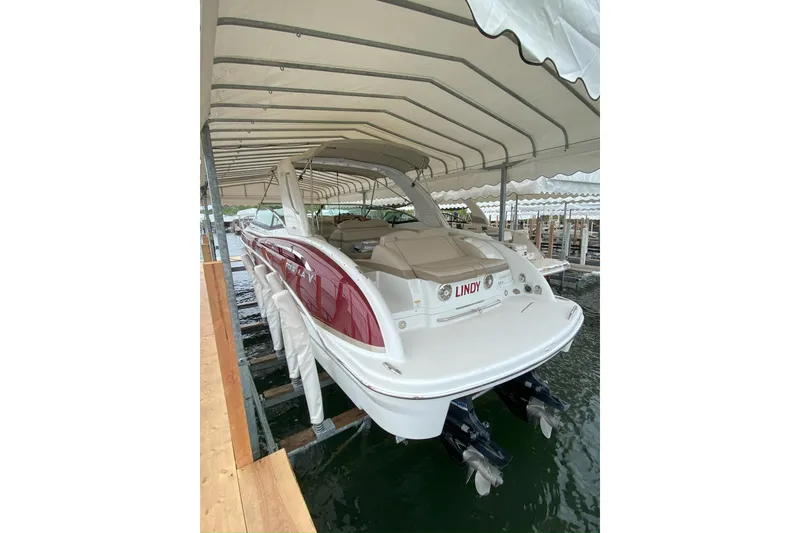 Slide: The Image of 2012 Formula 310 Sun Sport boat docked under a canopy. - 51