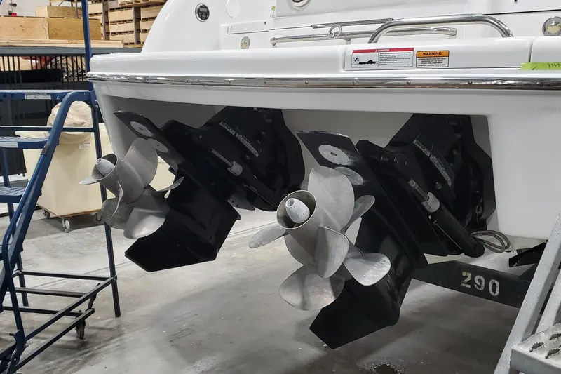 Slide: The Image of 2012 Formula 310 Sun Sport boat with dual propellers in a workshop setting. - 6