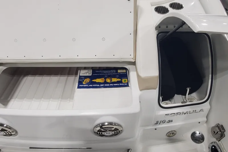 Slide: The Image of 2012 Formula 310 Sun Sport boat interior with storage compartment and speakers. - 8