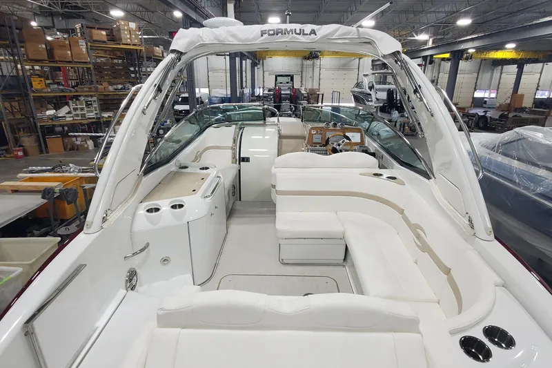 Slide: The Image of 2012 Formula 310 Sun Sport boat interior in a warehouse setting. - 9