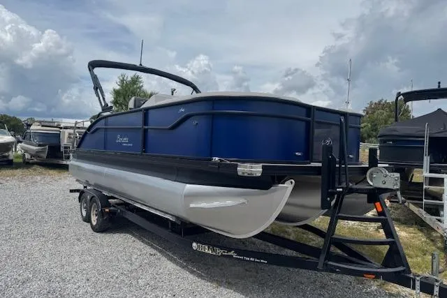 Slide: The Image of 2026 Barletta ARIA 22UC pontoon boat on trailer, parked outdoors. - 3