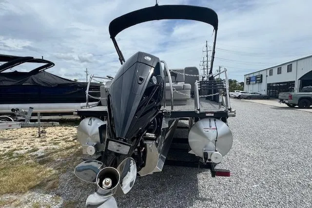 Slide: The Image of 2026 Barletta ARIA 22UC pontoon boat with powerful outboard motor, parked on gravel. - 8