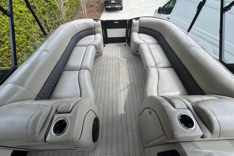 Slide: The Image of Luxurious seating on a 2019 Barletta L25UCL pontoon boat with beige upholstery. - 14