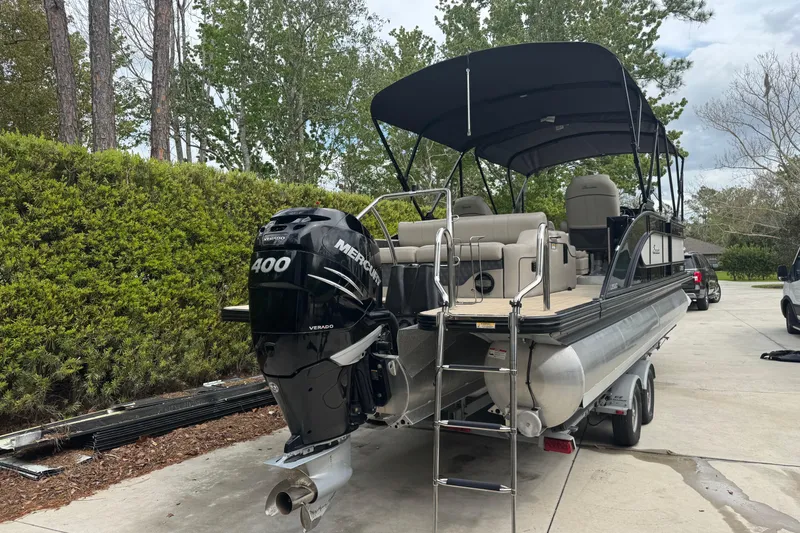 Slide: The Image of 2019 Barletta L25UCL pontoon boat with Mercury 400 Verado engine, parked on a trailer. - 3