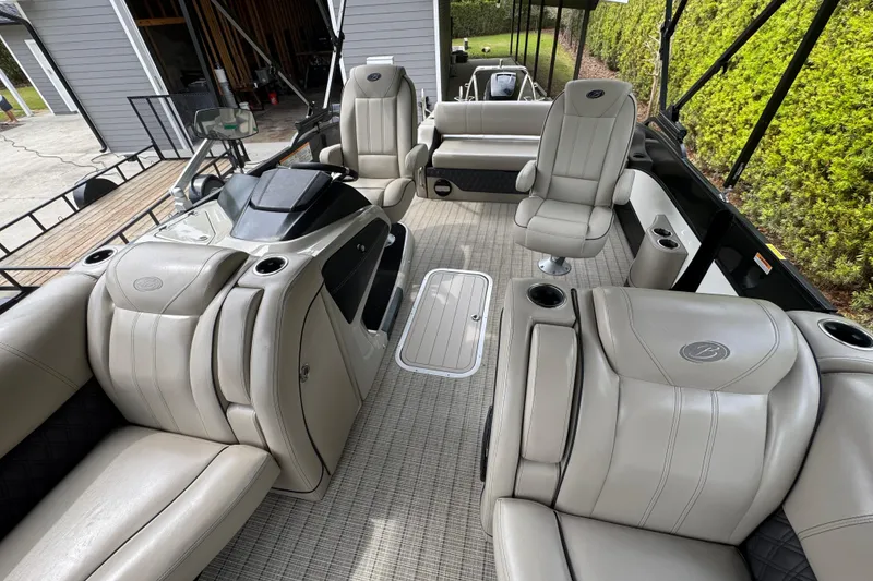 Slide: The Image of 2019 Barletta L25UCL pontoon boat interior with luxurious seating and modern helm. - 8