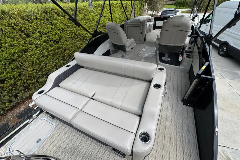 Slide: The Image of 2019 Barletta L25UCL pontoon boat interior with plush seating and cup holders. - 9