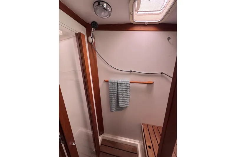 Slide: The Image of Shower area in 2004 Sabre 42 Fly Bridge yacht with wooden accents and towel rack. - 22